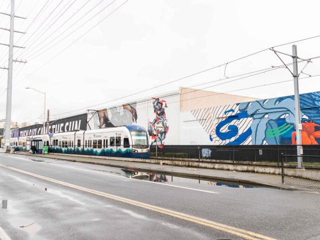 Train by a mural