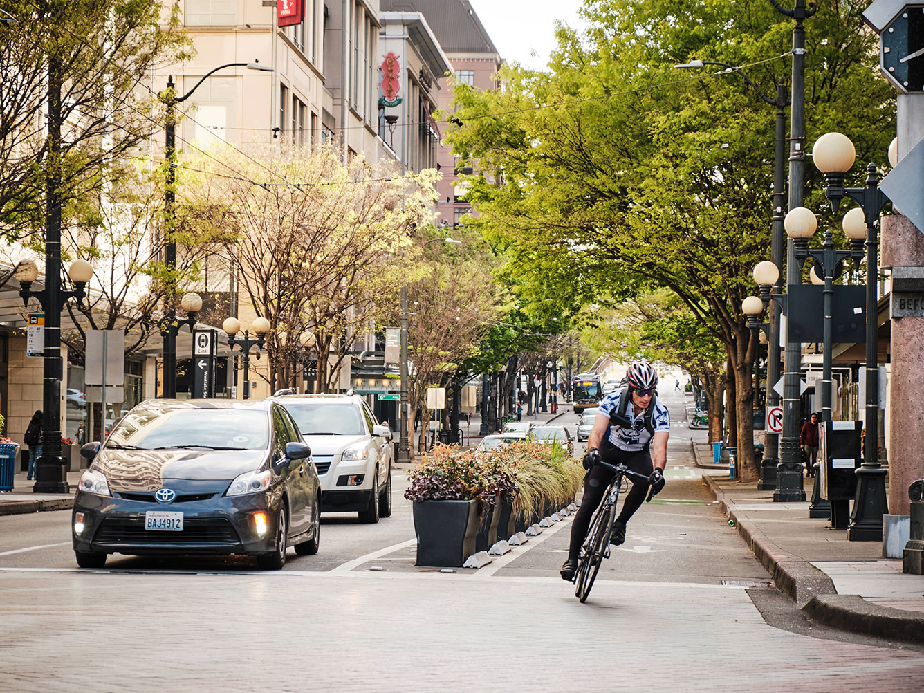 Drivers and biker on morning commute in downtown Seattle