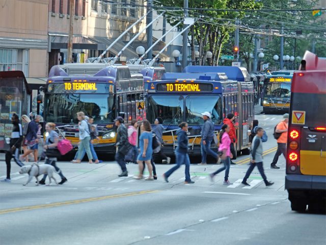 Busy downtown Seattle street with pedestrians and buses