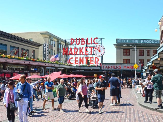 Visitors at sunny Pike Place Market in downtown Seattle
