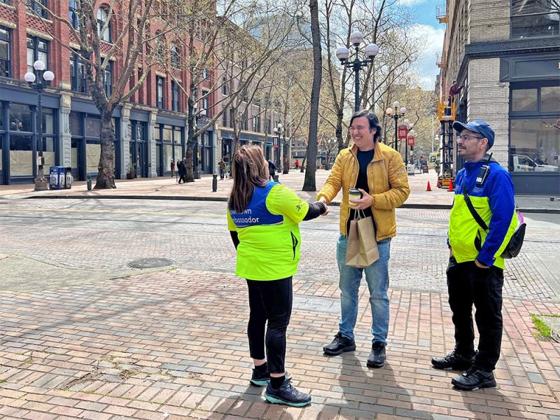 Safety ambassadors talking to a downtown visitor