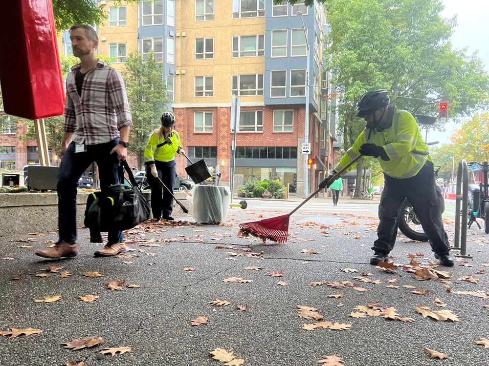 Downtown Ambassador raking leaves