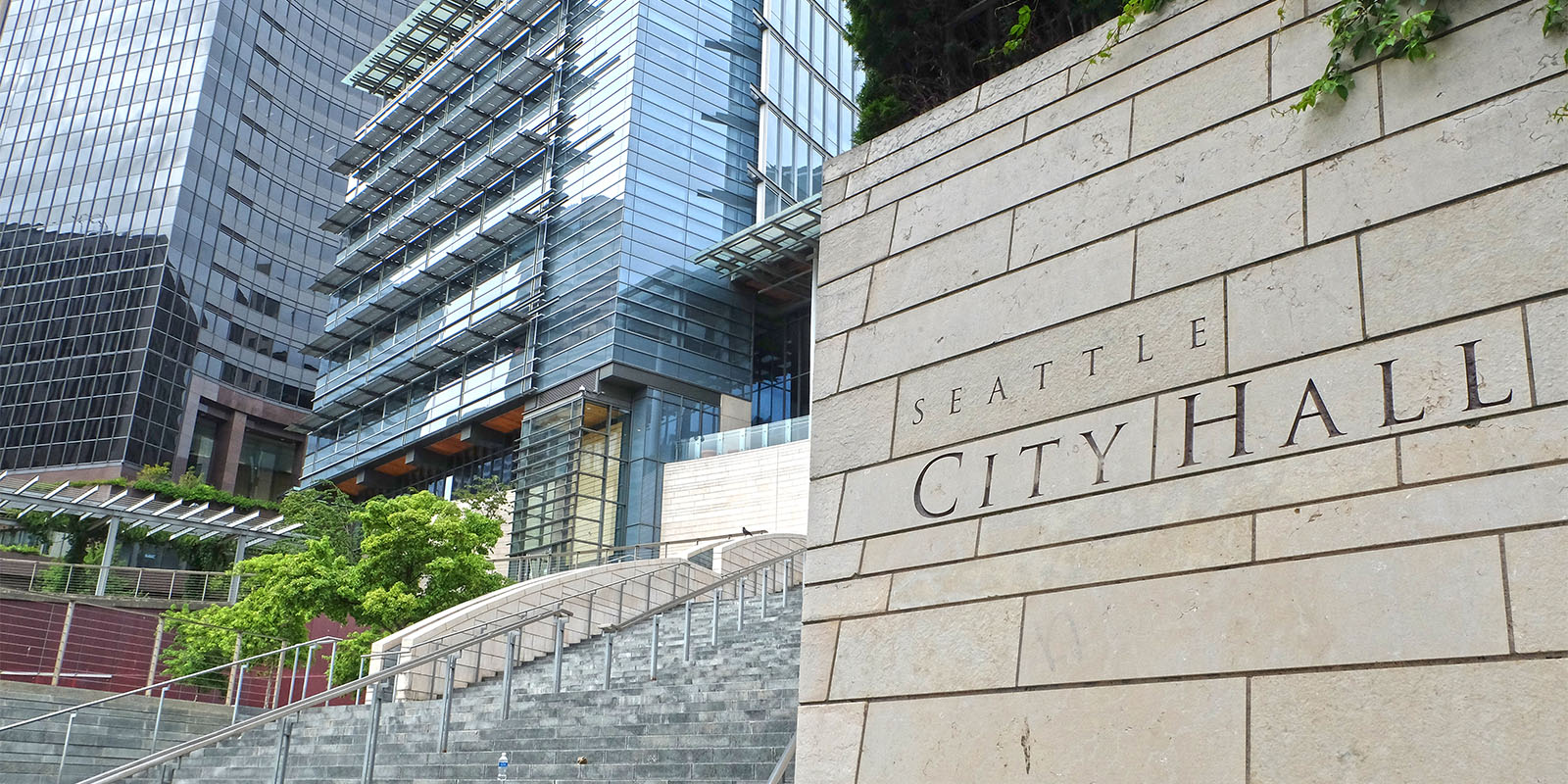 Seattle City Hall: exterior sign with buildings, plants and steps