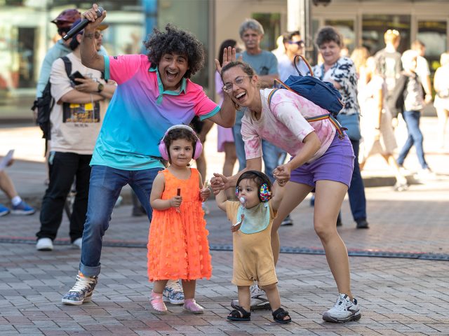 DJ dancing and singing with a family