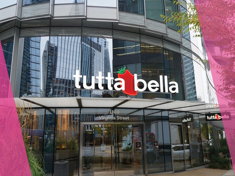 Tutta Bella sign with glass windows, surrounded by bright pink border on sides.