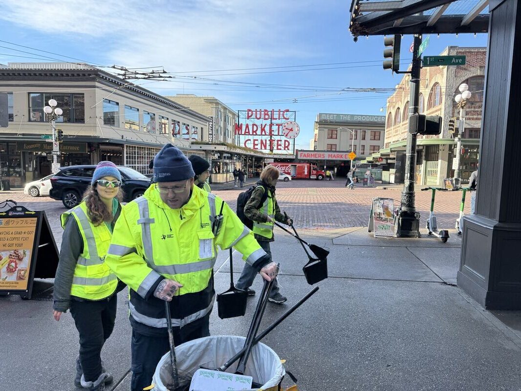 MID ambassadors and Uplift Northwest members clean the streets of downtown Seattle near Pike Place Market.