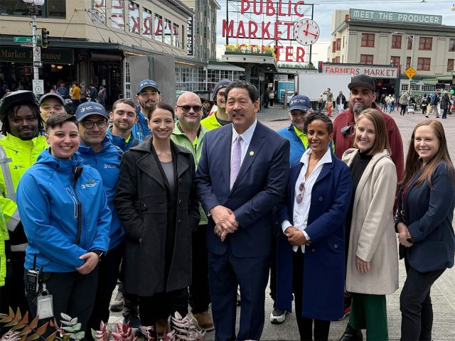 Attendees and speakers at the opening of First & Pike, including Mayor Harrell and downtown ambassadors