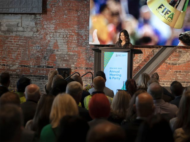 Mari Horita speaking in front of a crowd at Annual Meeting.