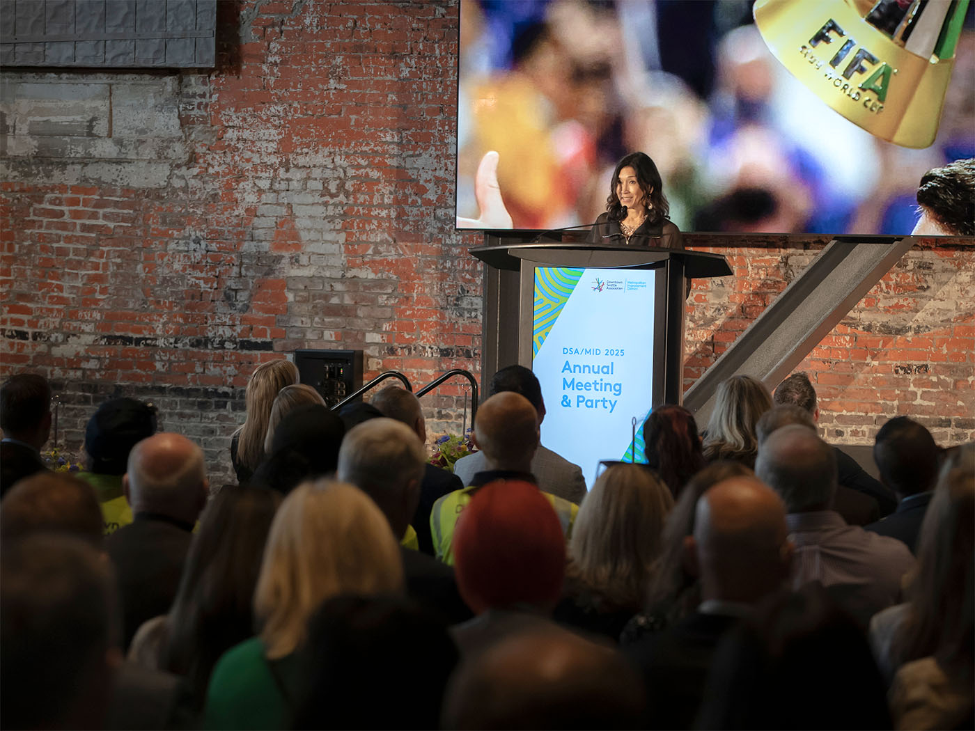 Mari Horita speaking in front of a crowd at Annual Meeting.