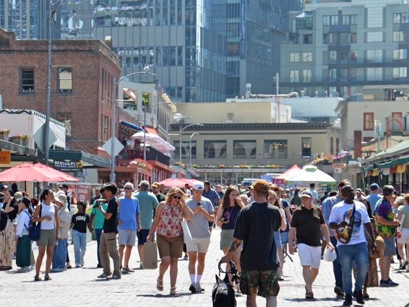 Visitors on a sunny day to Pike Place Market in downtown Seattle.