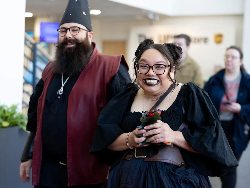 Two people in costume smiling