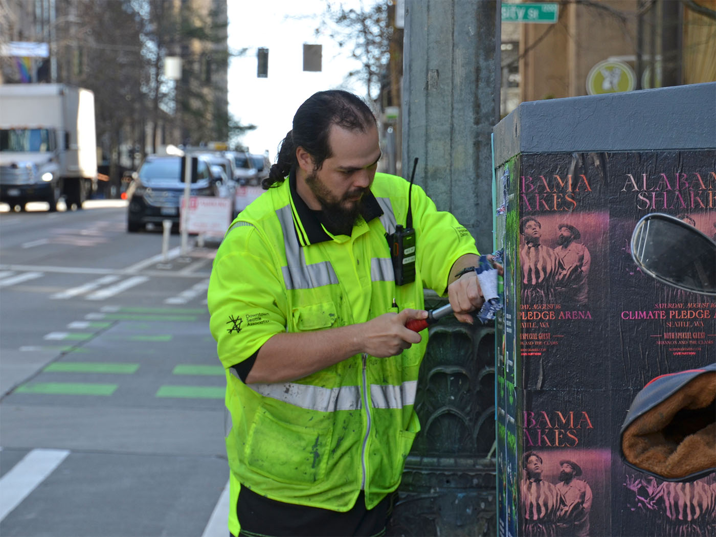 Downtown ambassador removing posters