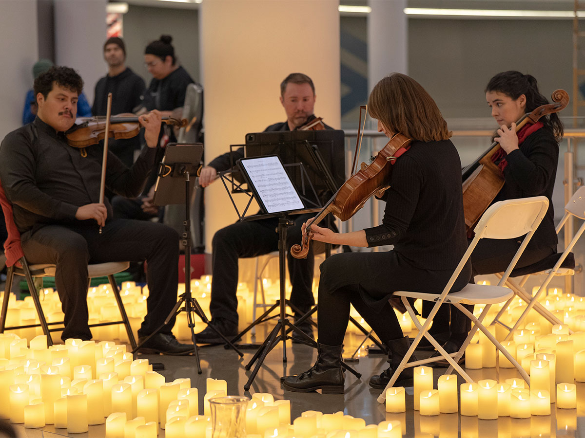 String musicians surrounded by candles at Pacific Place mall in downtown Seattle