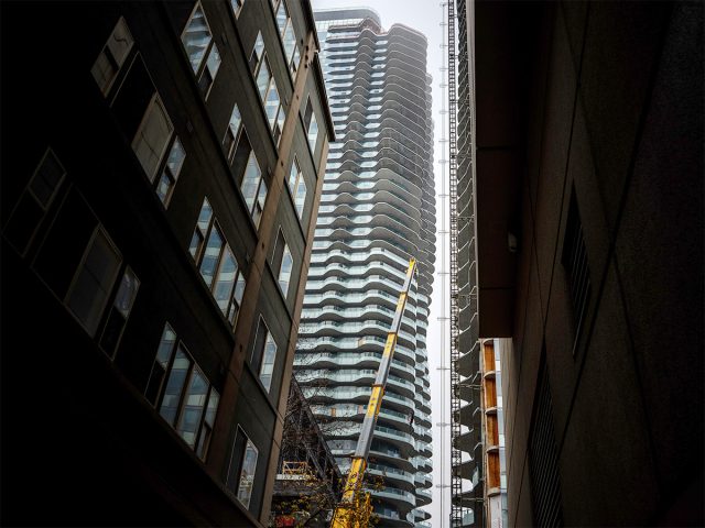 Looking up a corridor at tall buildings with texture and windows: 1200 Stewart