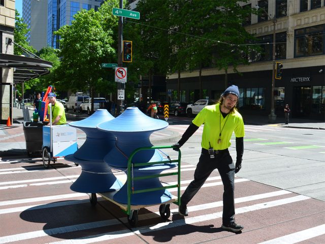 Downtown ambassador transporting chairs