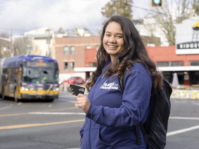 Woman holding Orca card smiling