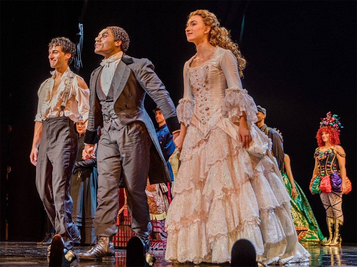 Courtesy of "The Phantom of the Opera" North American Tour. Actors on stage in costume receiving applause.