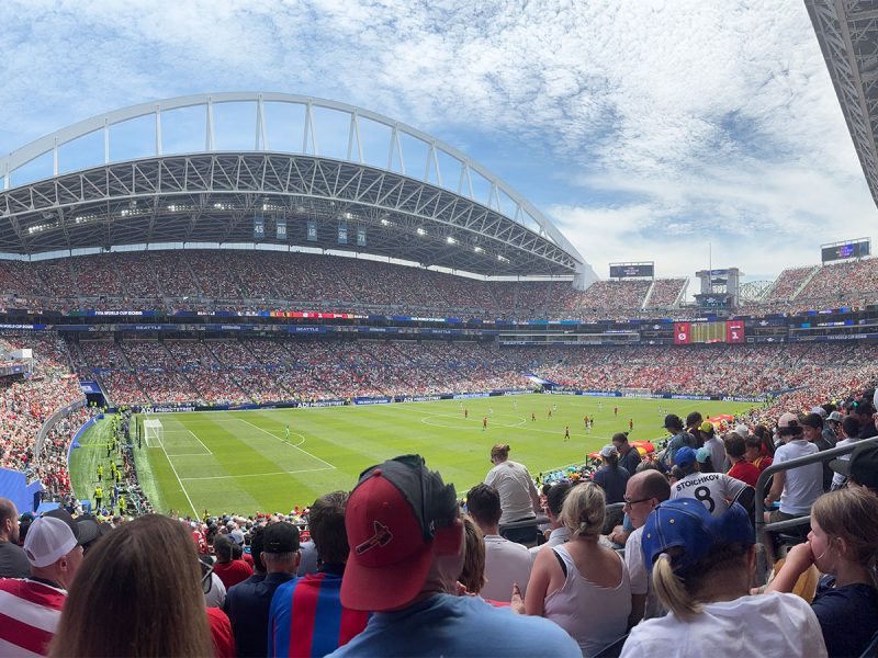 FIFA World Cup soccer game in Seattle: fans look out at the pitch, partially cloudy sky