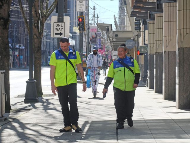DSA/MID ambassadors walk along Third Avenue in downtown Seattle