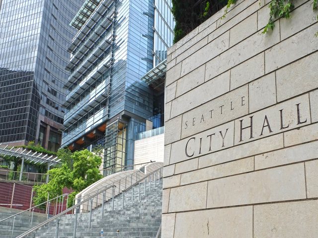 Seattle City Hall: exterior sign with buildings, plants and steps